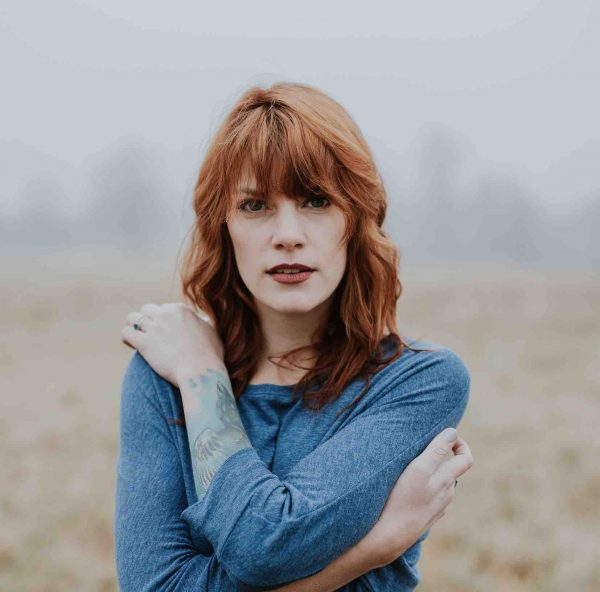 Red head women in misty field