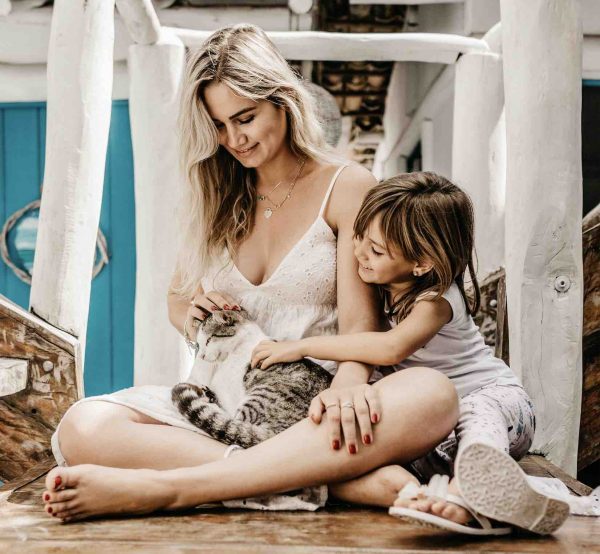 Mother and daughter petting cat