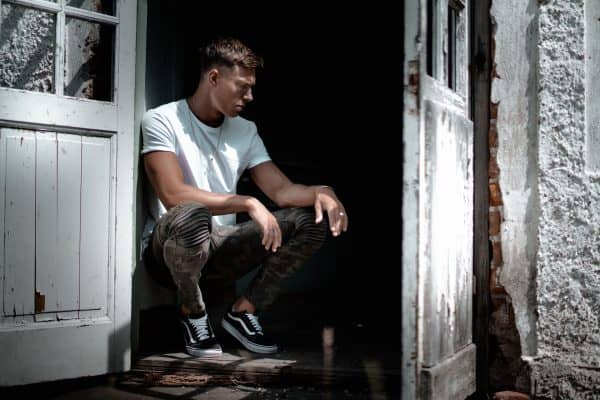 Man sitting in doorway