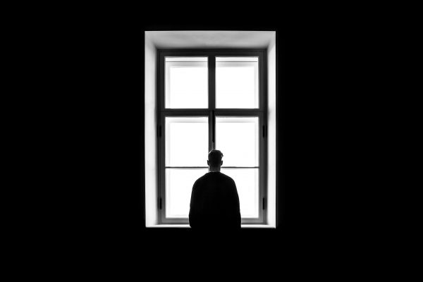 Man Staring Out Of Window